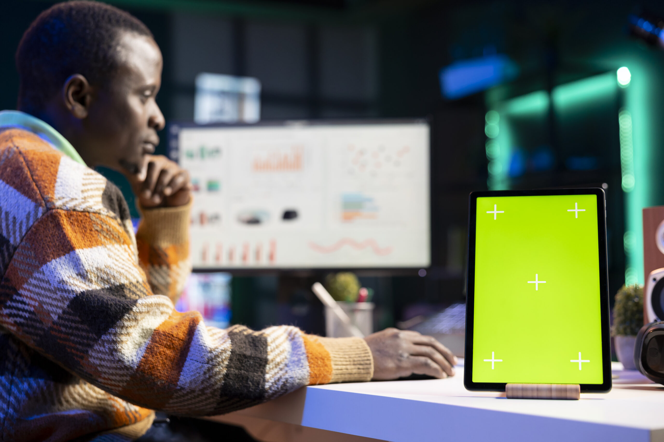 Skilled auditor looking over capital investments next to green screen, expert evaluating authorized fiscal stability on his computer. Self employed person checking economic data.